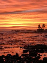 Scenic view of sea against romantic sky at sunset