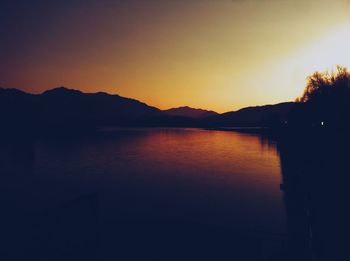 Scenic view of lake against clear sky during sunset