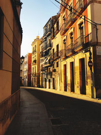 Empty alley amidst buildings in city