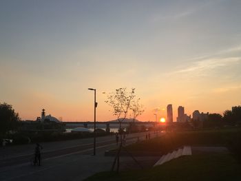 Silhouette city against sky during sunset