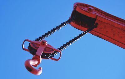 Low angle view of fire hydrant against clear blue sky