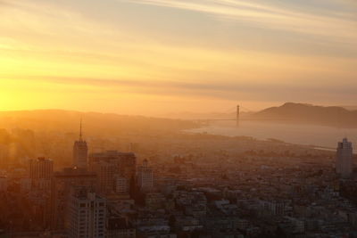 High angle view of buildings in city during sunset