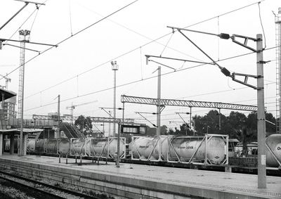 Train at railroad station against sky