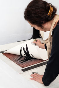 Midsection of woman working on table