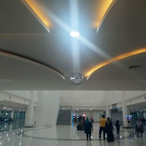 People walking in illuminated modern building