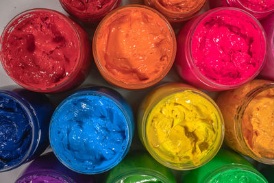 Directly above shot of multi colored paint bottles