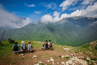 Tourists sitting on mountain