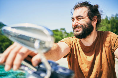 Portrait of smiling man holding camera