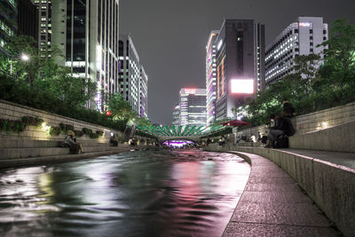 Illuminated city street at night