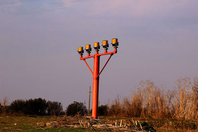 Information sign on field against sky