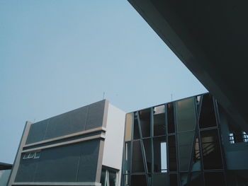 Low angle view of modern building against clear blue sky