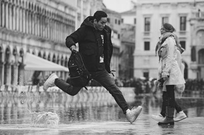 People jumping in city during winter