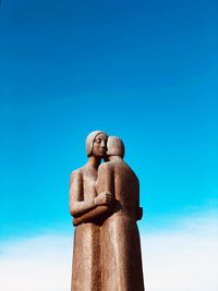 Low angle view of statue against blue sky