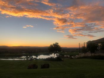 Scenic view of field against sky during sunset