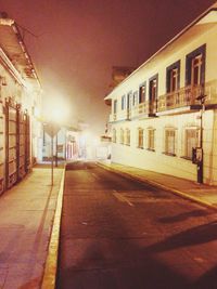 Illuminated street lights in city at night