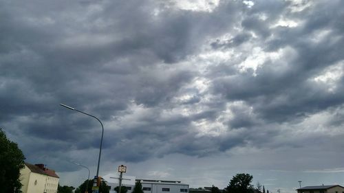 Low angle view of storm clouds over city