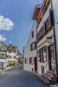 Houses in town against sky