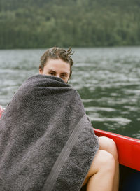 Portrait of man sitting on boat in lake