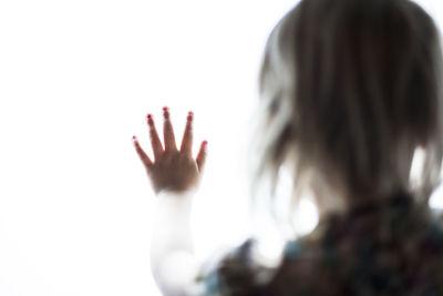 Girl with hand in front of her