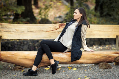 Portrait of young woman sitting on bench