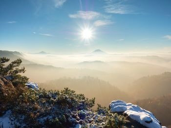 Freeze autumn trek, rocks covered with first fresh snow. stony peak, foggy valley. winter misty day