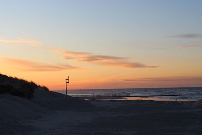 Scenic view of beach against sky during sunset