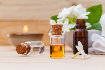 Close-up of aromatherapy oil in glass bottle on table