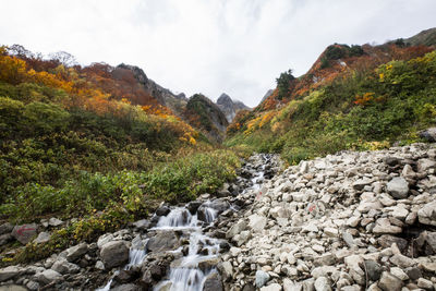 Scenic view of waterfall against sky