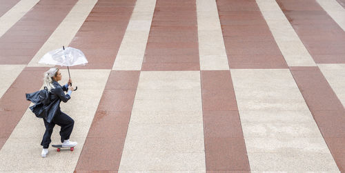 High angle view of man walking on zebra crossing