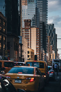 Traffic on city street amidst buildings