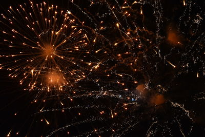 Low angle view of firework display at night