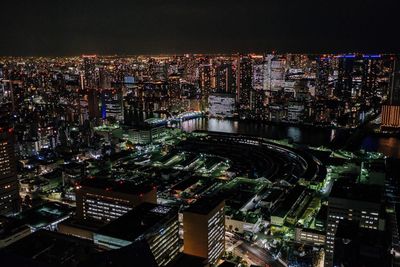 High angle view of city lit up at night