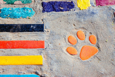 Top view on pieces of multicolored ceramic tiles decorated in garden. old pavement of tiles textured