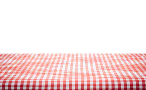 Close-up of red table against white background