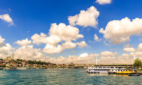 Sailboats in sea against sky