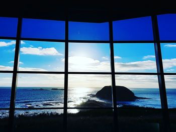 Scenic view of sea against sky seen through window