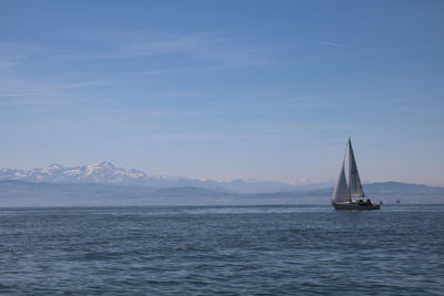 Sailboat sailing on sea against sky