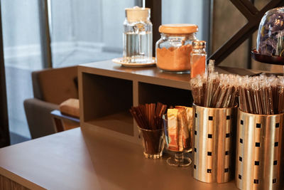 Close-up of containers on counter in coffee shop