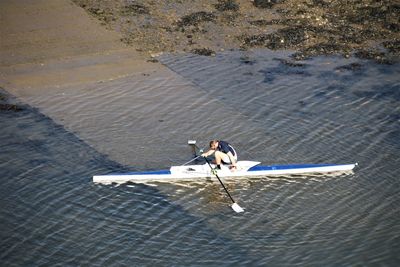 High angle view of man skateboarding on shore