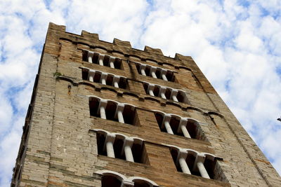 Low angle view of old building against cloudy sky