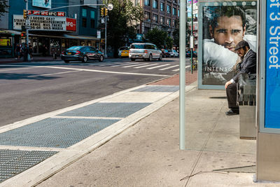 Man cycling on footpath in city