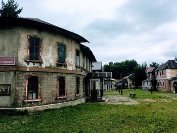 Abandoned house on field against sky