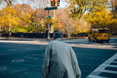 Rear view of a man on road in city