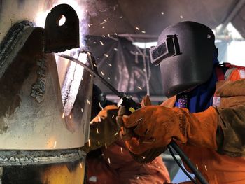 People working on metal structure