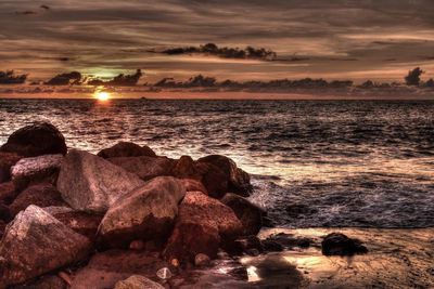 Scenic view of beach against sky during sunset