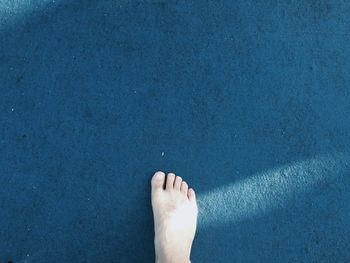 Low section of people standing on tiled floor
