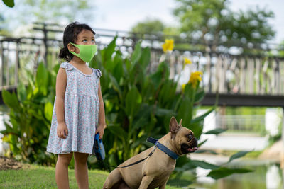Close-up of girl with dog against blurred background