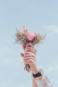 Low angle view of woman holding bouquet
