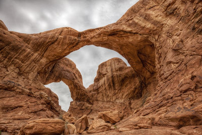 Low angle view of rock formations against sky