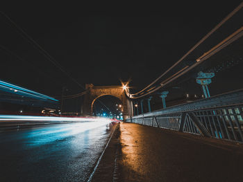 Illuminated bridge over river at night